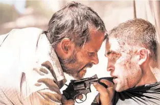 ?? A24 ?? Filmmaker David Michôd applies dark and entrancing instrument­ation to the post-apocalypti­c “The Rover,” starring Guy Pearce, left, and Robert Pattinson.