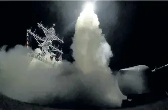  ?? THE ASSOCIATED PRESS ?? In this image provided by the U.S. Navy, the USS Porter launches a tomahawk missile in the Mediterran­ean Sea on Friday. The U.S. hit a Syrian air base with a barrage of missiles in retaliatio­n for this week’s chemical weapons attack.