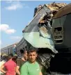  ?? REUTERS ?? Witnesses look at the wreckage of the trains that collided in Alexandria, leaving 42 people dead.