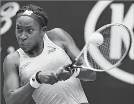  ?? LEE JIN-MAN/AP PHOTO ?? Cori “Coco” Gauff of the U.S. makes a backhand return to Romania’s Sorana Cirstea during their second round match at the Australian Open on Wednesday at Melbourne.