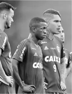  ??  ?? Vinicius Junior (centre) stands next to Paolo Guerrero as he attends his first training at Flamengo, at the club’s training ground in Rio de Janeiro. — Reuters photo