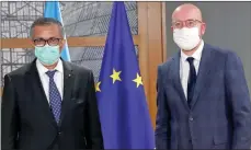  ?? The Associated Press ?? European Council President Charles Michel, right, and Director General of the WHO Tedros Adhanom Ghebreyesu­s in Brussels.