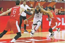  ?? NG HAN GUAN/ASSOCIATED PRESS ?? The United States’ Khris Middleton tries to get past Turkey defenders during a Group E game Tuesday for the FIBA Basketball World Cup at the Shanghai Oriental Sports Center in Shanghai. The U.S. beat Turkey, 93-92.