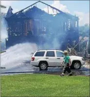  ?? MARIAN DENNIS — DIGITAL FIRST MEDIA ?? A fire destroyed a home on the 100 block of Gristmill Lane. People inside escaped without injury.