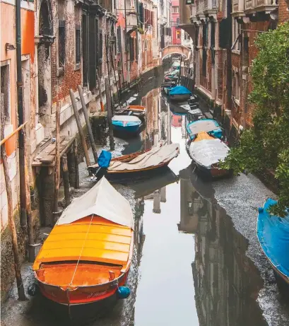  ??  ?? Unos botes atascados por la marea baja en un canal de Venecia. 30 de enero de 2018