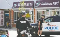  ?? LARRY WONG/ FILES ?? Police patrol the downtown Edmonton Chinatown district on Thursday, after two recent random murders in the area.
