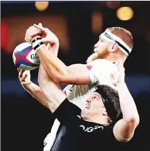  ??  ?? England’s Brad Shields, (top), and New Zealand’s Scott Barrett jump for the ball in a line out during the rugby union internatio­nal match between England and New Zealand at Twickenham stadium in London, Nov 10.(AP)