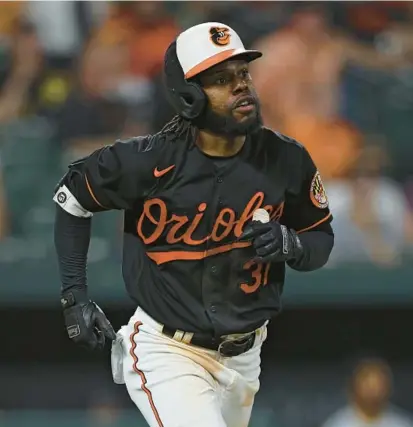  ?? PATRICK SMITH/GETTY ?? Cedric Mullins watches his three-run home run to complete the cycle Friday against the Pirates at Camden Yards.