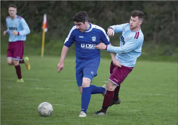  ??  ?? Declan Carstairs of Roundwood is tracked by Larry Kenna of St Anthony’s.