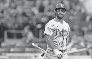  ?? ADAM HUNGER/AP ?? Phillies designated hitter Bryce Harper reacts after striking out against the Mets on Saturday in New York.