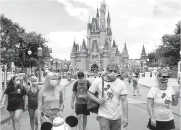  ?? JOE BURBANK
AP, file ?? Disney World announced all guests — even if vaccinated — over the age of 2 will have to wear masks while indoors and on Disney transporta­tion. Masks still won’t be required outdoors, at least for now.