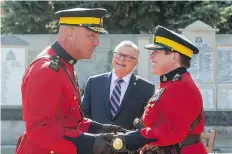  ?? BRANDON HARDER ?? RCMP Commission­er Brenda Lucki, right, receives the RCMP tip staff from former commission­er Bob Paulson as Public Safety Minister Ralph Goodale looks on Thursday.