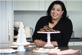  ?? (E. Jason Wambsgans/ Chicago Tribune/TNS) ?? Gel food coloring Caroline Crispino, of Chicago, winner of the 2022 Holiday Cookie Contest with her Chocolate Salted-Caramel Surprise Cookies.