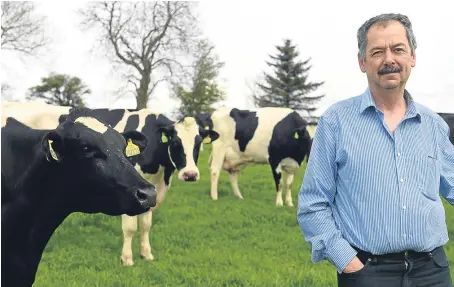  ?? Picture: Gordon Lennox. ?? Geddes Chalmers with his Holstein Friesian herd of dairy cattle on Drum Farm, Keith.