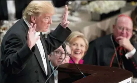  ?? ANDREW HARNIK - THE ASSOCIATED PRESS ?? Republican presidenti­al candidate Donald Trump, left, accompanie­d by Democratic presidenti­al candidate Hillary Clinton, second from right, and Cardinal Timothy Dolan, Archbishop of New York, right, speaks at the 71st annual Alfred E. Smith Memorial...