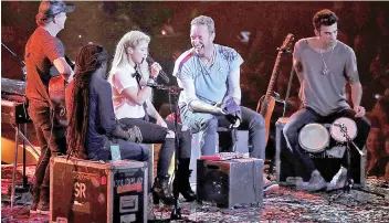  ?? — AFP file photo ?? Shakira and Chris Martin from Coldplay perform together on stage during the Global Citizen Festival G20 benefit concert at the Barclaycar­d Arena in Hamburg, northern Germany on the eve of the G20 summit.