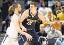  ?? David Zalubowski Associated Press ?? IVICA ZUBAC, left, tries his best to defend fellow center Nikola Jokic.