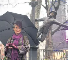  ?? Picture: PA. ?? Patricia Ward, widow of Gene Kelly, alongside a statue of the Hollywood legend.