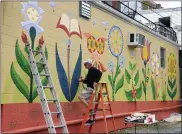  ?? MICHELLE N. LYNCH— MEDIANEWS GROUP ?? Mike Miller of West Reading, a Wyomissing School District art teacher, puts the finishing touches on the mural Sunday, April 25. The mural is the first of several planned for Sander Alley in Kutztown.