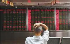  ?? AFP ?? Stock price movements at a brokerage in Beijing. Simmering trade tensions between the US and China are set to erupt into a full-blown trade war tomorrow.