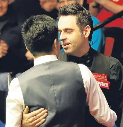  ?? PA. ?? Ronnie O’Sullivan wishes Ding Junhui all the best after the Chinese player ended his hopes.