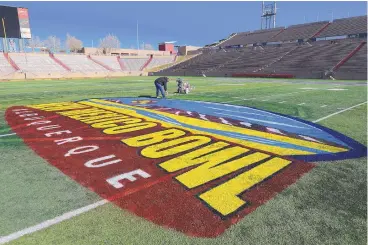  ?? ADOLPHE PIERRE-LOUIS/JOURNAL ?? Leroy Tapia finishes the New Mexico Bowl logo at the Dreamstyle Stadium on Thursday.