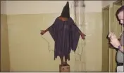  ?? THE ASSOCIATED PRESS ?? This late 2003photo obtained by The Associated Press shows an unidentifi­ed detainee standing on a box with a bag on his head and wires attached to him in the Abu Ghraib prison in Baghdad, Iraq.