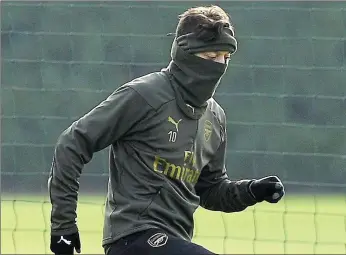  ??  ?? Cover star:Mesut Ozil, who has made just one start for Arsenal this year, trains this morning ahead of the Europa League last-32, first-leg tie against BATE Borisov tomorrow
