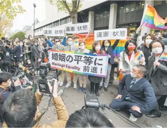  ?? — AFP photo ?? Plaintiffs and supporters react in front of the Tokyo District Court in Tokyo following a ruling in a lawsuit filed by same-sex couples seeking damages from the government.