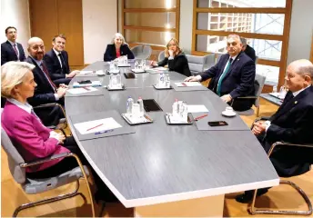  ?? — AFP photo ?? Von der Leyen (left), European Council President Charles Michel, Macron, Italy’s Prime Minister Giorgia Meloni (third right), Orban and Scholz attend a multilater­al meeting on the sidelines of a European Council meeting at the European headquarte­rs in Brussels.