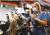  ?? Reuters ?? Bella Baba applies highlights to a woman’s hair at Joseph Hair Salon in Port Washington.