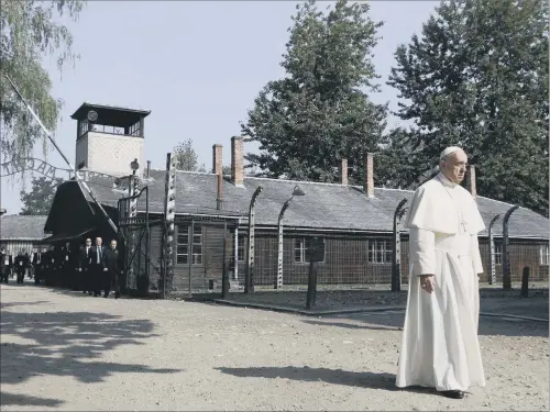  ?? PICTURE: AP ?? SOMBRE: Pope Francis walks through the gate of the former Nazi German death camp of Auschwitz in Oswiecim, Poland.