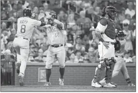  ?? AP/SCOTT KANE ?? St. Louis Cardinals catcher Yadier Molina (right) looks toward the outfield while Chicago Cubs’ Ian Happ (left) celebrates with Kyle Schwarber after hitting a two-run home run during the fifth inning on Saturday in St. Louis.