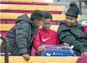  ?? Staff photo by Kayleigh Moreland ?? Emmanuel Lewis, 10, holds his new PlayStatio­n 4 after he won it in a raffle on Friday at the Liberty-Eylau Rader Dome. Emmanuel took part in the J.W. Blessings Christmas event started by Texarkana native and Olympic athlete Jarrion Lawson. Lawson...