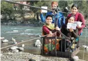  ?? PTI ?? Voters leave by a ropeway after casting their votes for Assembly elections, in Kullu on Thursday