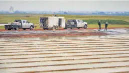  ?? OKLAHOMAN ARCHIVES] [PHOTO BY CHRIS LANDSBERGE­R, THE ?? Crews work to treat water at Newfield Exploratio­n Company’s Barton Water Recycling Facility in Kingfisher in this photo from July.