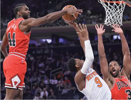  ?? ADAM HUNGER/AP ?? Patrick Williams, blocking a shot by the Knicks’ RJ Barrett on Monday night, doesn’t think comparison­s to former college teammate Scottie Barnes are apples to apples.