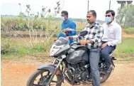  ??  ?? Thanjavur Collector M Govinda Rao riding pillion to reach a village to verify crop damage on Thursday