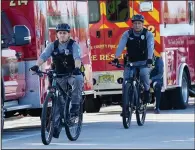  ?? (AP/Wilfredo Lee) ?? Bicycle-mounted police patrol near the federal courthouse before the arrival of former President Donald Trump on Thursday in Fort Pierce, Fla.