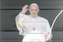  ?? ANDREW MEDICHINI — THE ASSOCIATED PRESS ?? Pope Francis delivers his blessing as he recites the Angelus noon prayer from the window of his studio overlookin­g St.Peter’s Square, at the Vatican, Sunday.