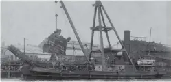  ??  ?? salvage steamer Standfast craning wreckage.