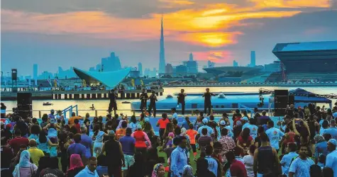  ?? Pictures: Ahmed Ramzan/Gulf News ?? People watch the ‘Boxing by TK MMA’ programme on the main stage at the Opening Weekend Carnival at Dubai Festival City.