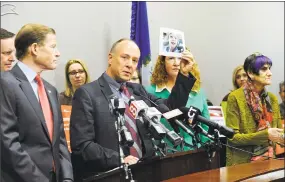  ?? Carol Kaliff / Hearst Connecticu­t Media ?? Mark Barden, founder and managing director of Sandy Hook Promise, holds up a photo of his son, Daniel, who died during the Sandy Hook School shooting in 2012. The STOP School Violence Act, signed by President Donald Trump on Friday, will award $100...