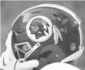  ??  ?? The Washington logo is seen on an NFL helmet.