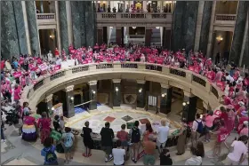  ?? (AP/Todd Richmond) ?? Dozens of protesters gather in the Wisconsin state Capitol rotunda on Wednesday in Madison, Wis., in hopes of convincing Republican lawmakers to repeal the state’s 173-year-old ban on abortions.