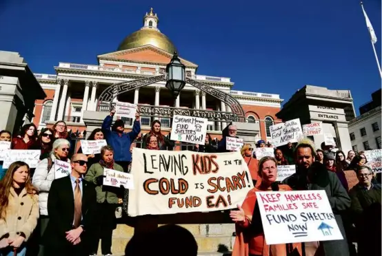 ?? JOHN TLUMACKI/GLOBE STAFF ?? Advocates and others rallied outside the State House on Tuesday, calling for the Healey administra­tion to uphold the right to shelter law for homeless families.