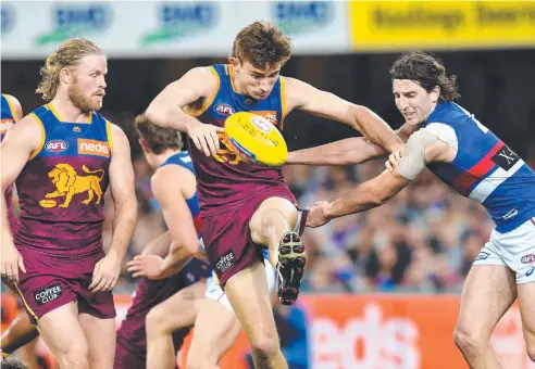  ??  ?? RISING STAR: Brisbane’s Harris Andrews (centre) gets a kick away against the Western Bulldogs at the Gabba. Picture: AAP