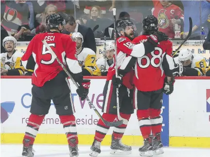  ?? TONY CALDWELL ?? Ottawa Senators forward Mike Hoffman is congratula­ted after scoring what proved to be the winning goal on Penguins goalie Matt Murray during third period action Tuesday night in Ottawa. The Senators defeated the Penguins 2-1 to force a Game 7 on...