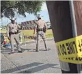  ?? SCOTT OLSON/GETTY IMAGES ?? Police stand guard outside Santa Fe High School, where an attack left 10 people dead.