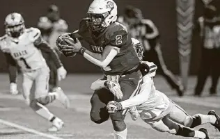  ?? Photos by Tom Reel / Staff photograph­er ?? Lanier quarterbac­k Fabian Miciel drags a Brackenrid­ge defender during the first half. Miciel scored on a 30-yard run and also threw a 43-yard touchdown pass in the second half.